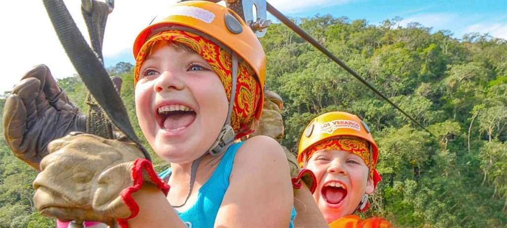 2 kids Zip Lining in Vallarta, Mexico.